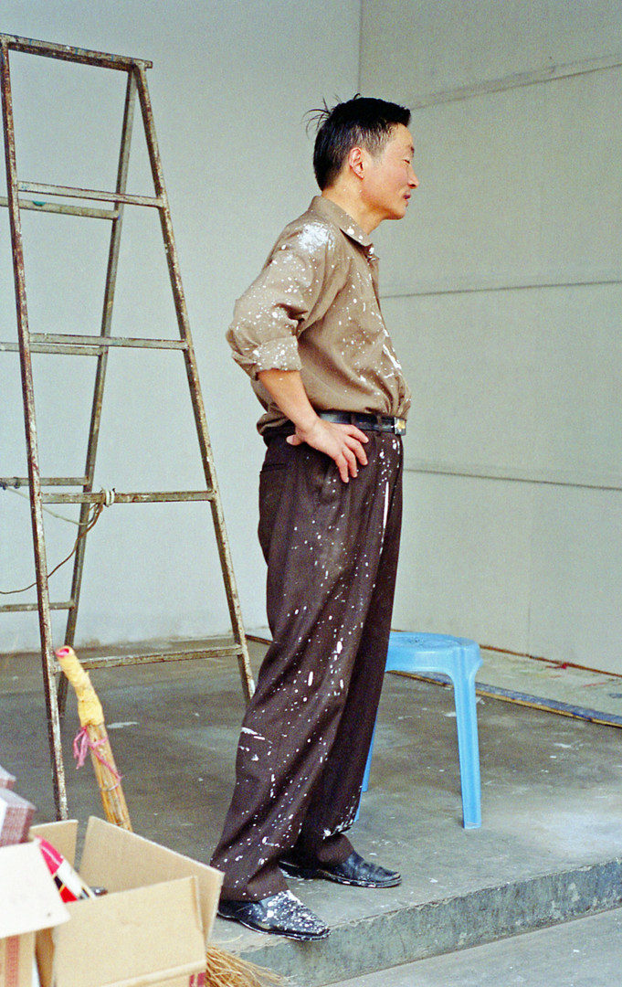 From Emma Sywyj's 'China' photography series &mdash; a painter standing in a workshop